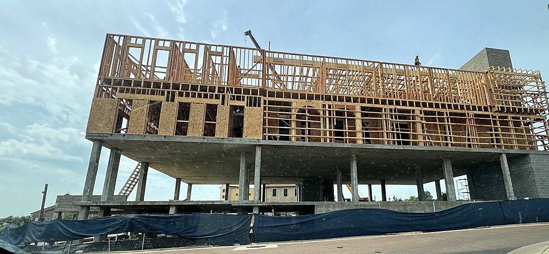 Wood framing over a concrete podium